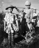 This Chinese child soldier, age 10, with heavy pack, was a member of an army division boarding a plane returning them to China, following the capture of Myitkyina airfield, Burma, under the allied command of US Major General Frank Merrill, May 1944.<br/><br/>

Chinese and allied troops had earlier crossed through the treacherous jungle of the Kumon Bum Mountains before attacking Japanese troops to the south. Exhaustion and disease led to the early evacuation of many Chinese and allied troops before the coming assault on Myitkyina town.